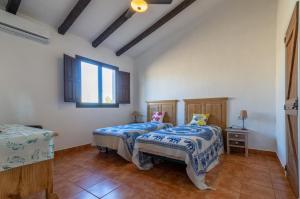 sypialnia z 2 łóżkami i oknem w obiekcie Casa Torres - Traditional Village Experience w mieście Cánovas
