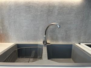 a sink with a faucet in a kitchen at Sparkling dream in Saronida +26 photos