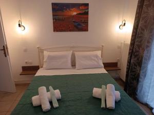 a bedroom with a bed with towels on it at Aegean Star in Apróvaton