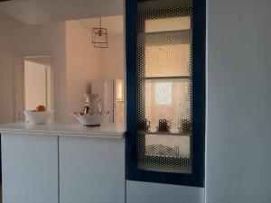 a kitchen with a counter with a glass window at Aegean Star in Apróvaton +49 photos