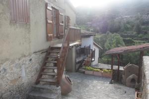 a house with stairs leading up to a building at Maritsa Lodge in Kakopetria