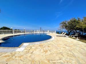 a swimming pool with a white fence around it at Nysa7 in Paphos City