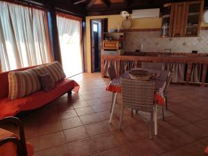 a kitchen and living room with a table and a couch at villa solare in Castellammare del Golfo +12 photos