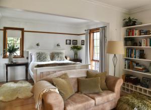a living room with a bed and a couch at Forth River Cottage in Forth