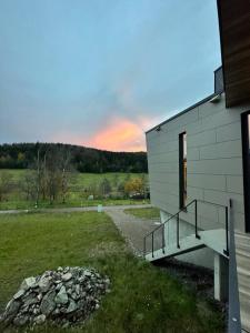 a building with a staircase next to a grass field at Tolle Bergvilla im Osterzgebirge in Kurort Altenberg