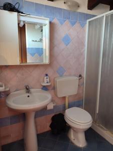 a bathroom with a sink and a toilet and a mirror at villa solare in Castellammare del Golfo