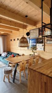 une salle à manger avec une grande table et des chaises en bois dans l'établissement Domek na Kleninie z gorącą balią, à Kamienica