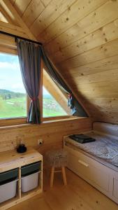 Habitación con cama, escritorio y ventana. en Domek na Kleninie z gorącą balią, en Kamienica