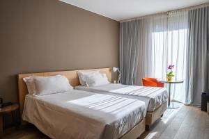 Rúm í herbergi á Parc Hotel Billia