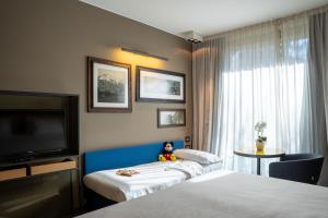 Rúm í herbergi á Parc Hotel Billia