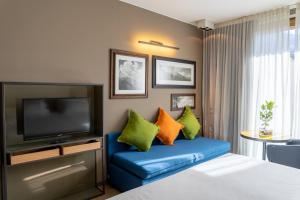 Camera con letto e TV di Parc Hotel Billia a Saint Vincent