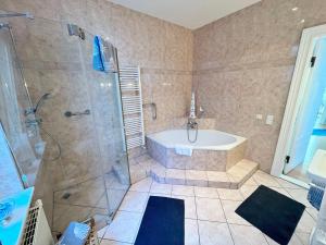 a large bathroom with a tub and a shower at Hotel Ambiente in Brake +61 photos