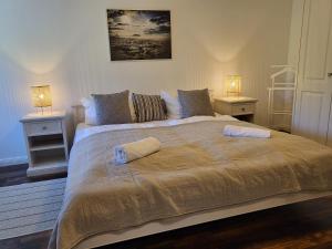 ein Schlafzimmer mit einem großen Bett mit zwei Nachttischen in der Unterkunft Ferienwohnung 6 im Mühlenhof in Sankt Peter-Ording
