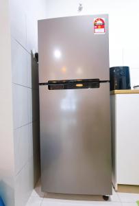 a stainless steel refrigerator in a kitchen at rumaKL at Majestic Maxim in Kuala Lumpur
