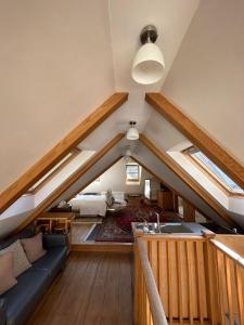 an attic room with a couch and a bed at 2 Westview in St. Brelade