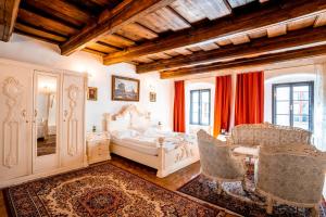 a bedroom with a bed and a table and chairs at Leylaria in Český Krumlov