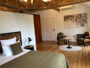 a bedroom with a bed and a table and chairs at Le Clos des Queyries in Bordeaux