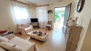 a living room with a couch and a table at Lourantos Studios & Apartments in Vathi