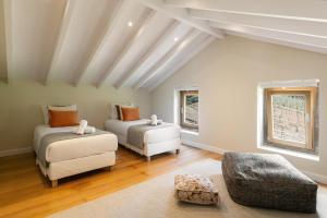 a living room with two beds and a couch at Casa do Vale in Óbidos +40 photos