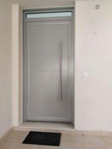 a white door with a black rug in front of it at Brand new spacious studio in Itea