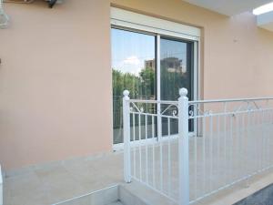 a balcony with a white railing and a large window at Brand new spacious studio in Itea
