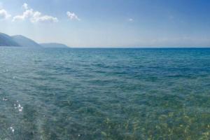 a large body of water with mountains in the background at Brand new spacious studio in Itea +2 photos