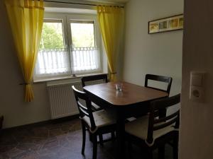 a dining room with a table and chairs and a window at Apartment near Kaifenheim with terrace in Kaifenheim