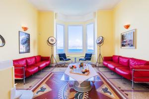 a living room with red couches and a table at LE CAP DE NICE VI4150 by RIVIERA HOLIDAY HOMES in Nice