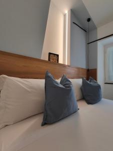a bedroom with a bed with two pillows on it at Casa Aicardi in Alassio