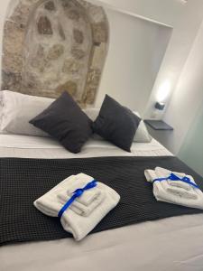 a hotel room with two white towels on a bed at Gargallo Suite Ortigia in Syracuse