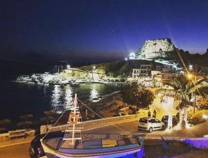 a boat is docked in a harbor at night at Grannys Luxury Villas in Karpathos Town