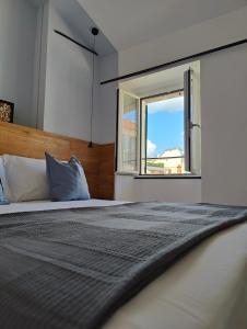 a bedroom with a large bed with a window at Casa Aicardi in Alassio