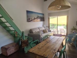 ein Wohnzimmer mit einem Tisch und einem Sofa in der Unterkunft Nature Oasis near Barcelona with swimming pool in Sant Cugat del Vallès