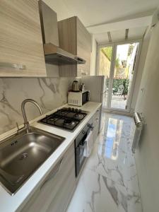 a kitchen with a sink and a stove top oven at Calle de le Pazienze Apartments in Venice