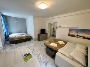 a room with two beds and a table in it at Calle de le Pazienze Apartments in Venice