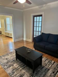 a living room with a couch and a coffee table at Secret Oasis In The Heart Of Hartford in Hartford