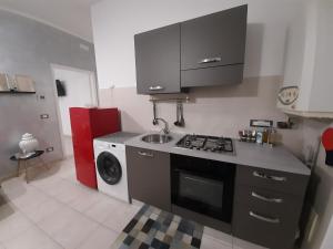 a kitchen with a sink and a washing machine at La Nchioscia in La Spezia