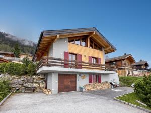 a large house with a garage in front of it at Chalet Etoile Polaire in Nendaz