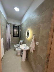 a bathroom with two toilets and a sink and a shower at Cosy 2BR Apartment near Tirana Airport - SELF CHECK-IN 24hr in Tirana