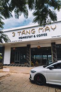 a white car parked in front of a building at 3 Tầng Mây (Homestay & Coffee) in Ấp Ða Lôc