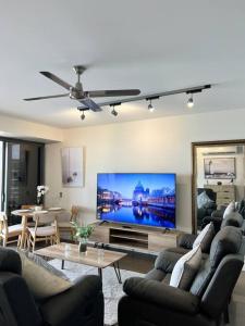 a living room with a large flat screen tv at Sea Renity at Waterfront - SEAVIEW in Darwin