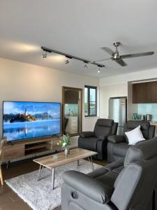 a living room with a large flat screen tv at Sea Renity at Waterfront - SEAVIEW in Darwin
