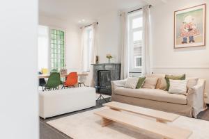 a living room with a couch and a fireplace at De Pastorie Diksmuide in Diksmuide