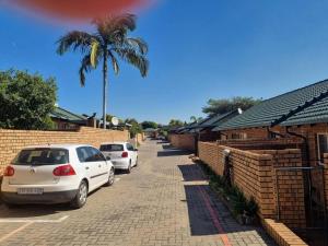 a row of cars parked in front of houses at Home away from Home in Pretoria