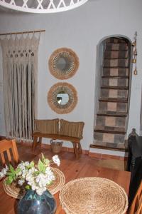 a living room with a bench and mirrors on the wall at Acogedora casa rural en Olvera ,La Morada in Olvera