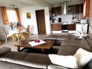 a living room with a couch and a table at Ferienwohnung Kling in Bischofsheim an der Rhön