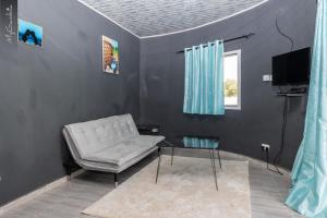 sala de estar con silla y mesa de cristal en Seaview 1-Bed Suite on Cape Point Beach Bakau en Bakau