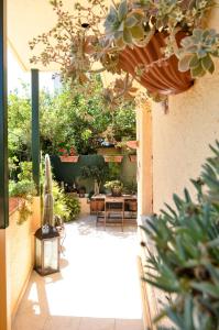 a patio with a table and chairs and plants at Antalia Home in Kalamata