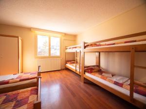 a room with three bunk beds and a window at Chalet Annapurna in Les Deux Alpes +27 photos
