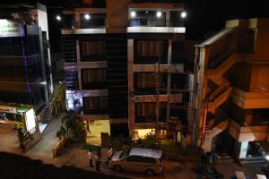 a car parked in front of a building at night at EVEREST PARK RESIDENCY in Tiruchchirāppalli